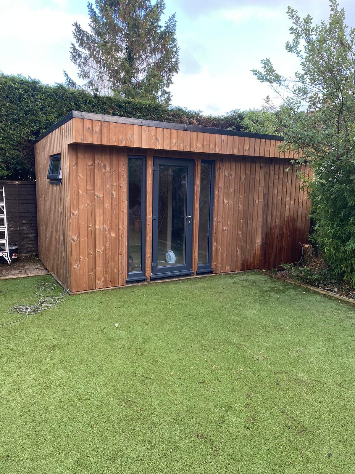 Timber-clad garden room with glazed doors